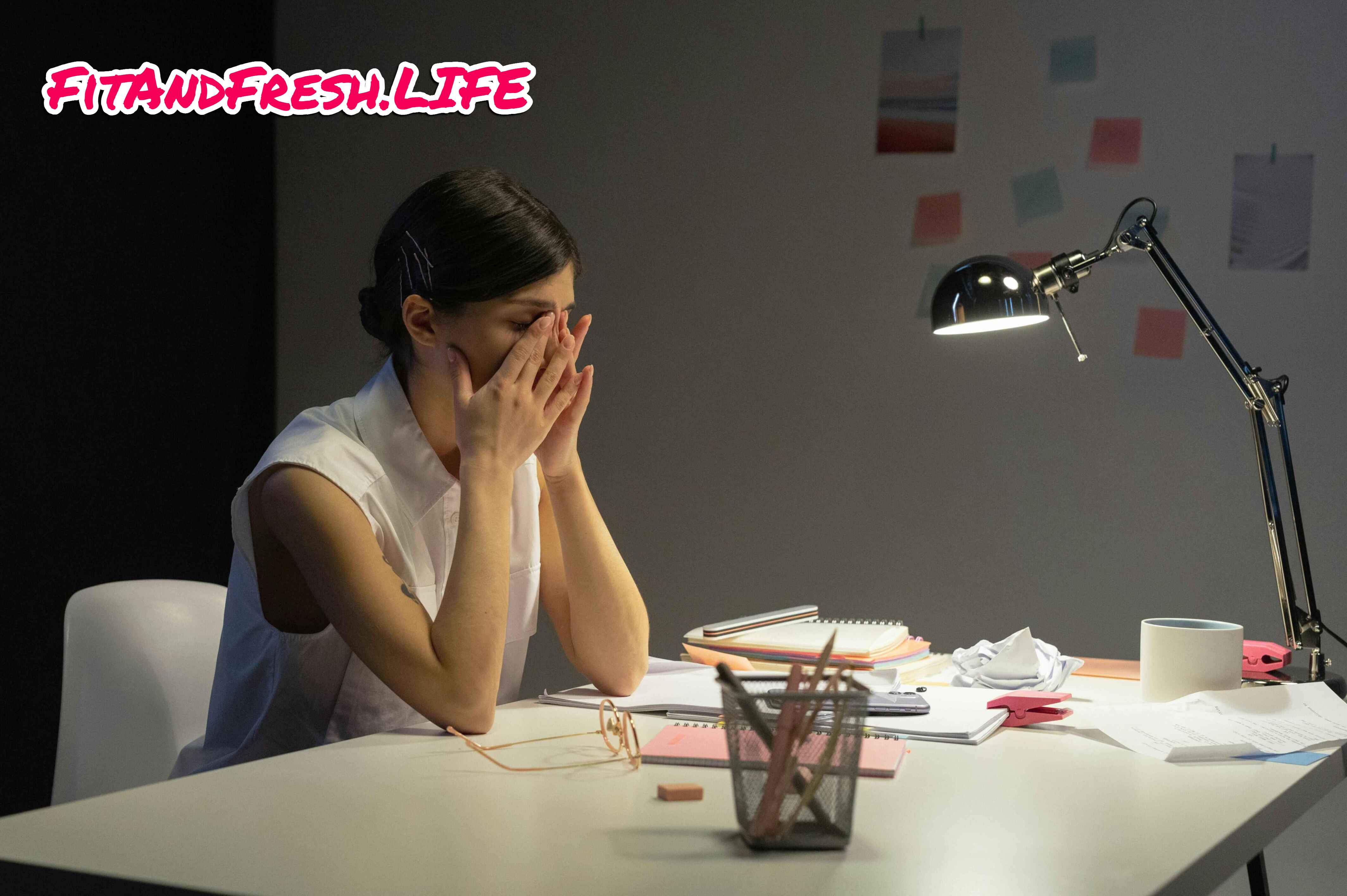 A girl sit's in front of laptop with alot of headache