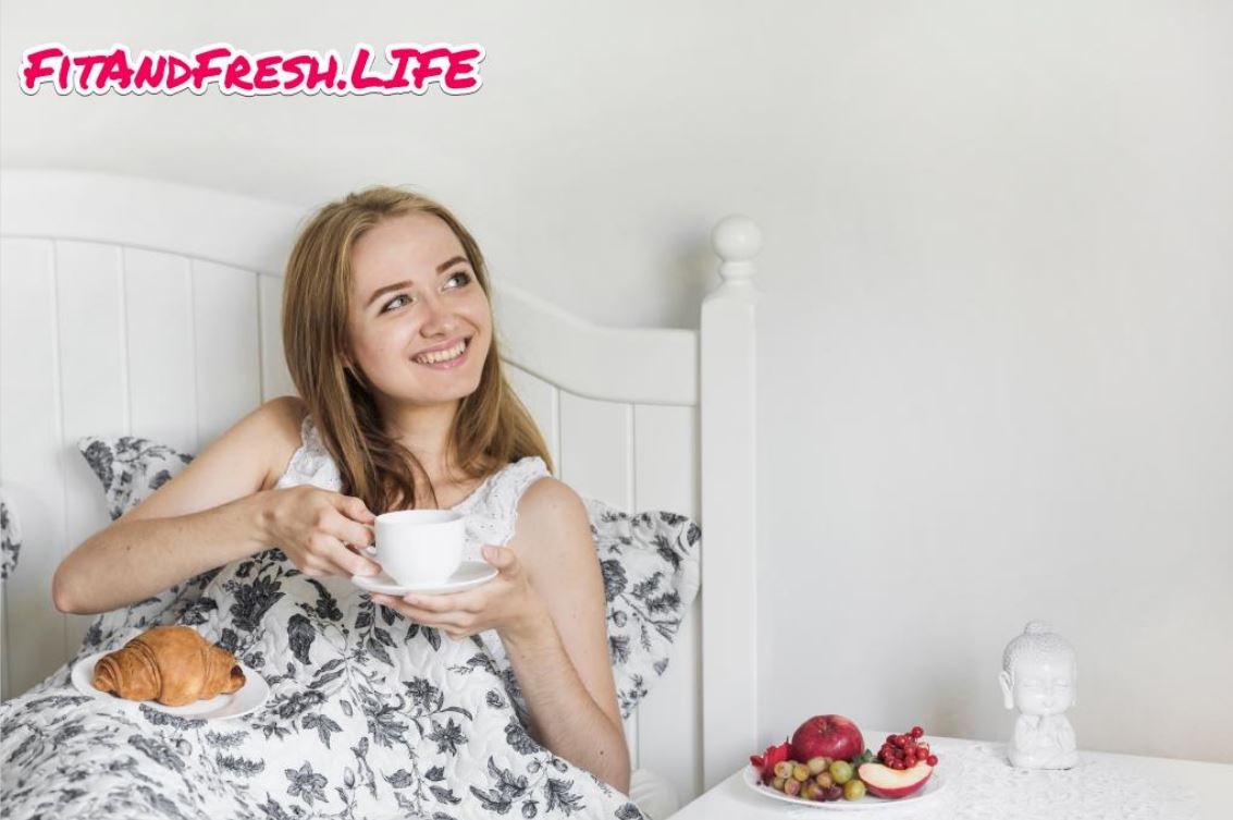 A girl is on Bed with having a cup of tea and a fresh mood