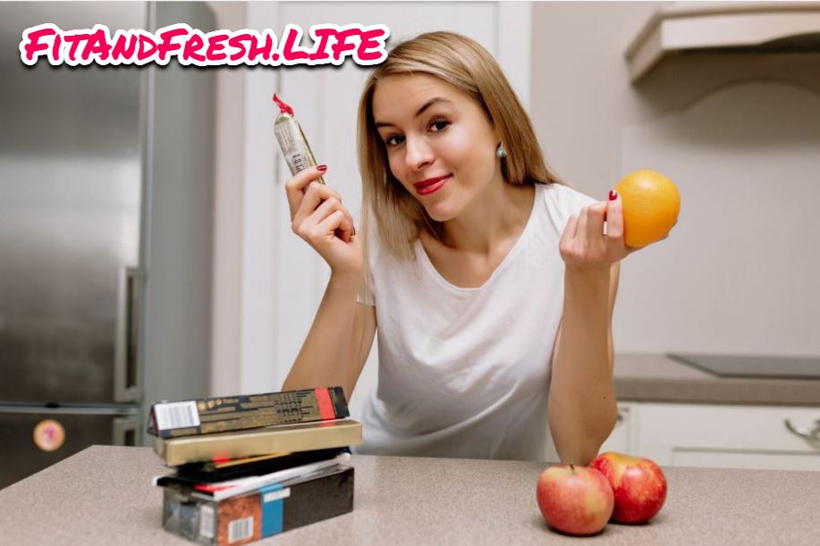 A girl picks chocklate on its left hand and orange on its right hand shows the difference between natural sugar and injected sugar