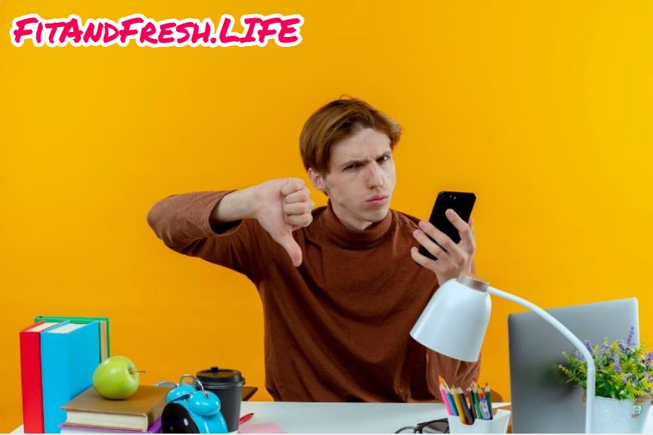 A man showing thumbs down to screen